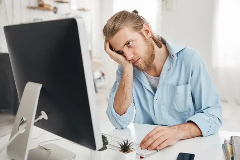 Frustrierter Mann vor einem Computer, der seine Website selbst gemacht hat.